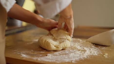 a woman kneading dough in a kitchen