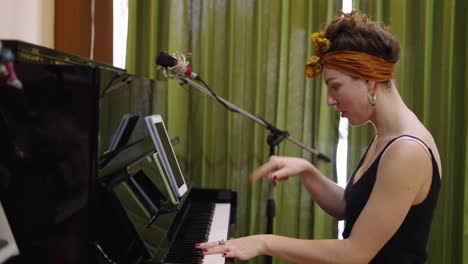 woman playing piano with microphone setup