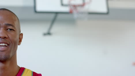 African-American-man-stands-in-a-basketball-court,-with-copy-space