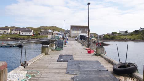 static shot of the pier and docked fishing boats on the isle of scalpay