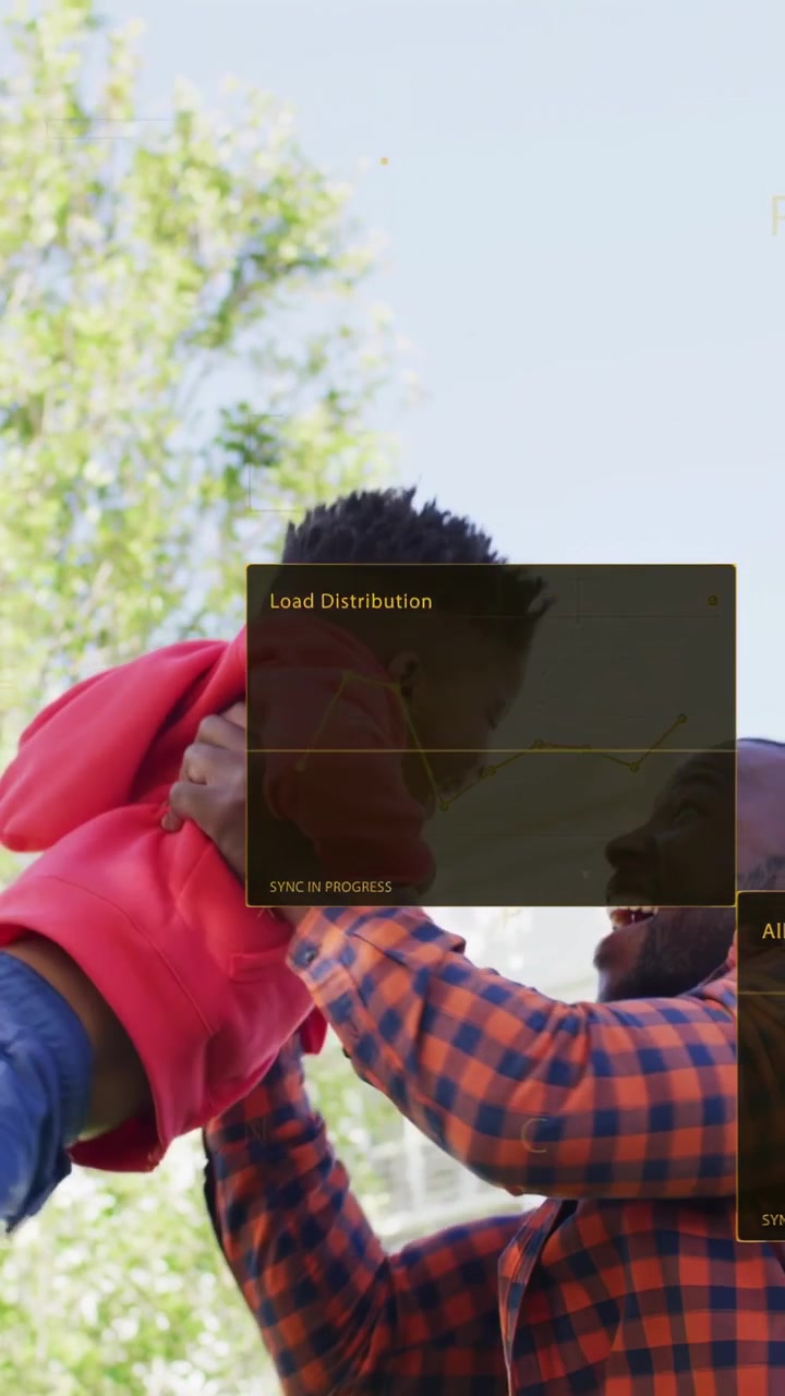 Vertical video: Dad playing, lifting son, swinging and catching under tree, tech charts overlaying