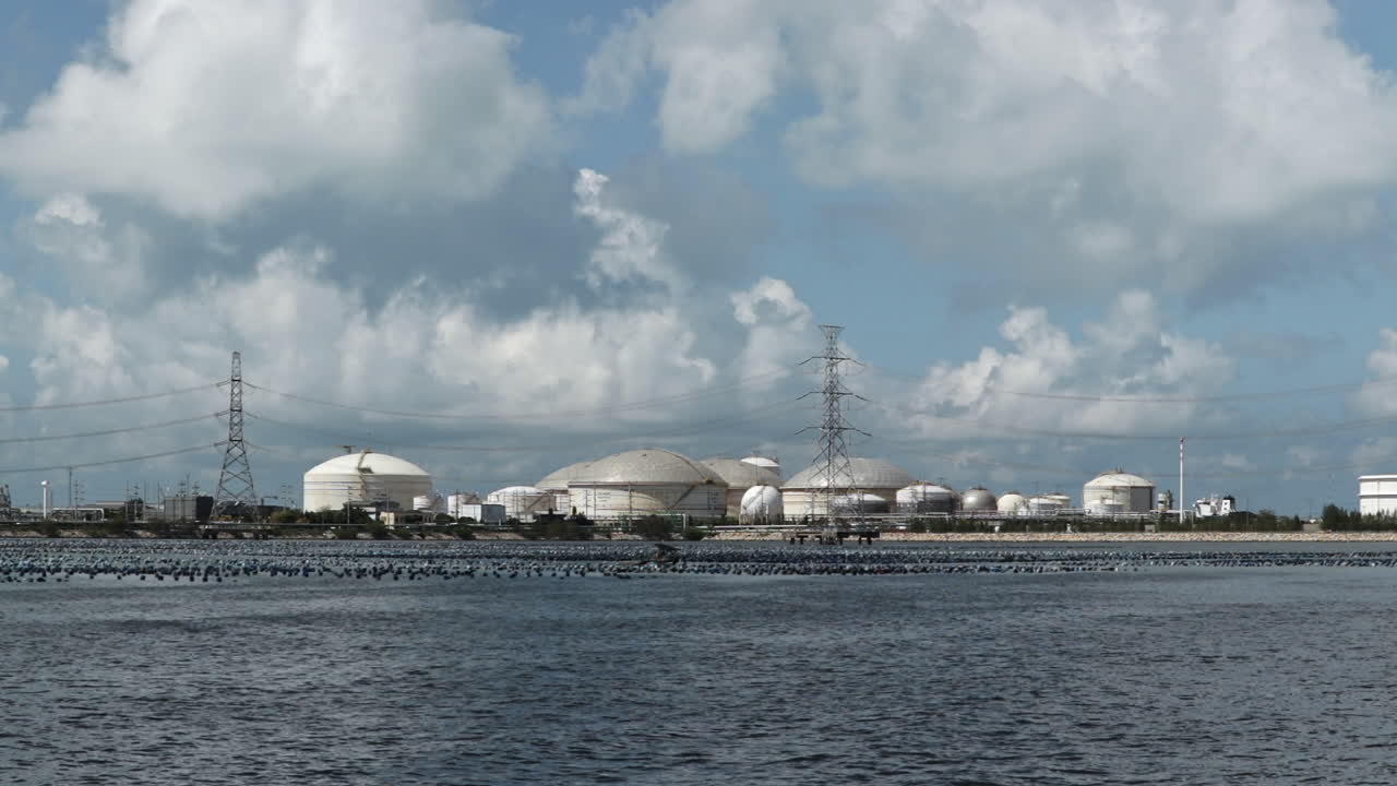 Large petrochemical storage tanks by the sea near Map Ta Phut. Industrial oil and gas storage infrastructure in a coastal refinery complex