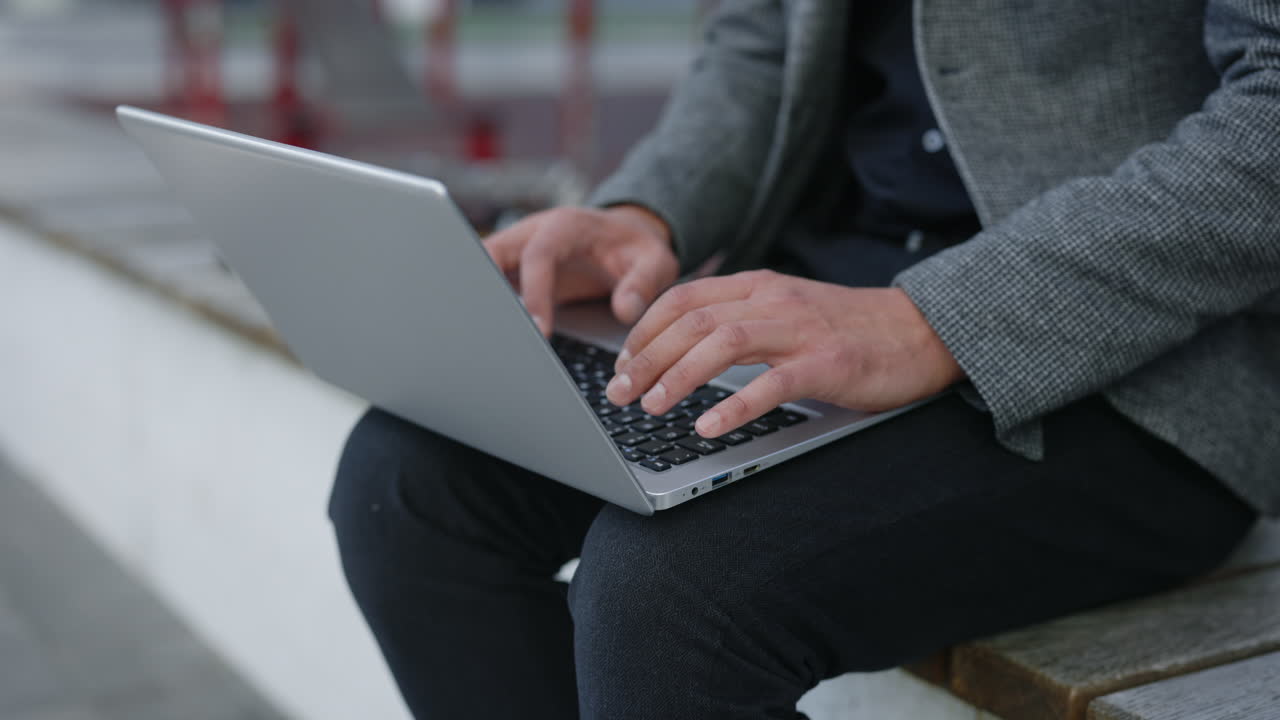 Man working on laptop outdoors