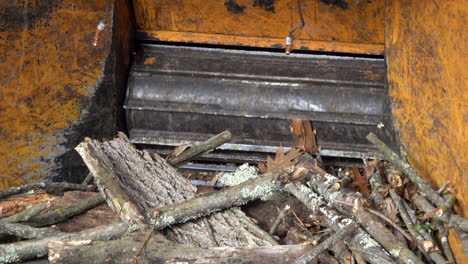 close-up of the rotating blades of a wood chipper