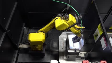 automated welding machine operating within a factory setting