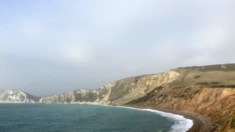 beautiful aerial shot of chalk cliffs and headland on the coast of dorset, england