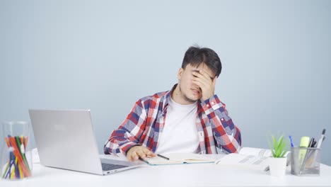 man looking at laptop gets frustrated.