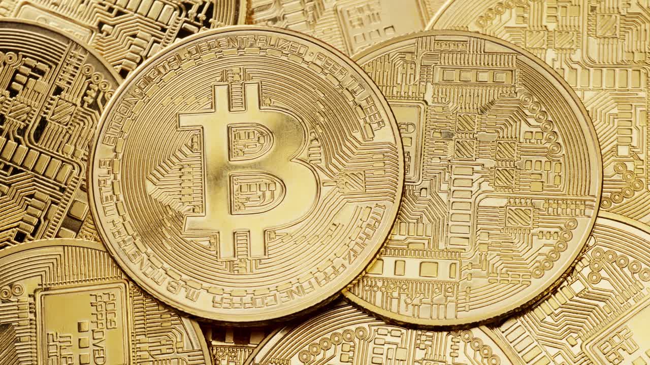 Bitcoin coins stacked, showcasing their detailed and intricate designs with technology influence