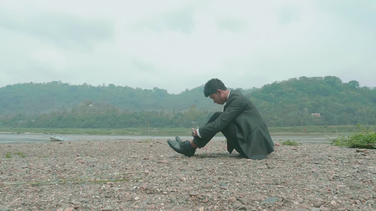 Lonely Businessman by the River