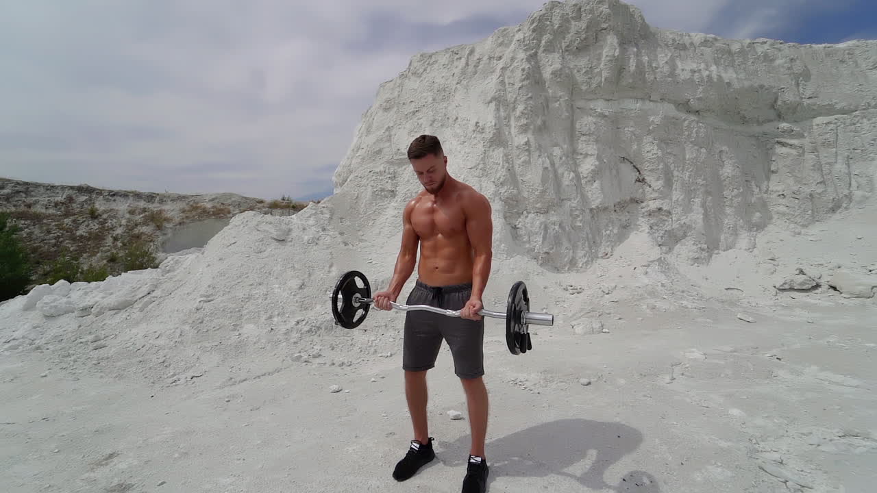 Man training outdoor. Muscular young man working out on nature