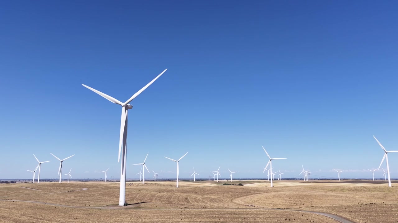 Many wind turbines spinning on a large wind farm, producing clean and renewable electricity in Rio Vista, California, contributing to a sustainable and ecological power generation future