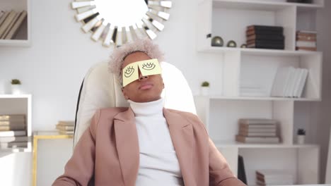 young african american woman worker sleeps in office due to fatigue and overwork