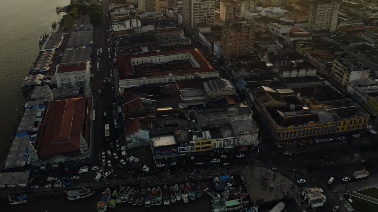 A slow tilting up aerial drone shot of the Ver-o-Peso Market in Belém, Brazil at sunrise.