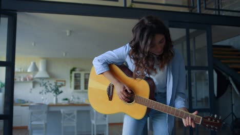 girl performing composition on guitar. musician playing song on instrument