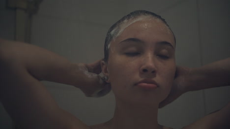 woman washing her hair in the shower