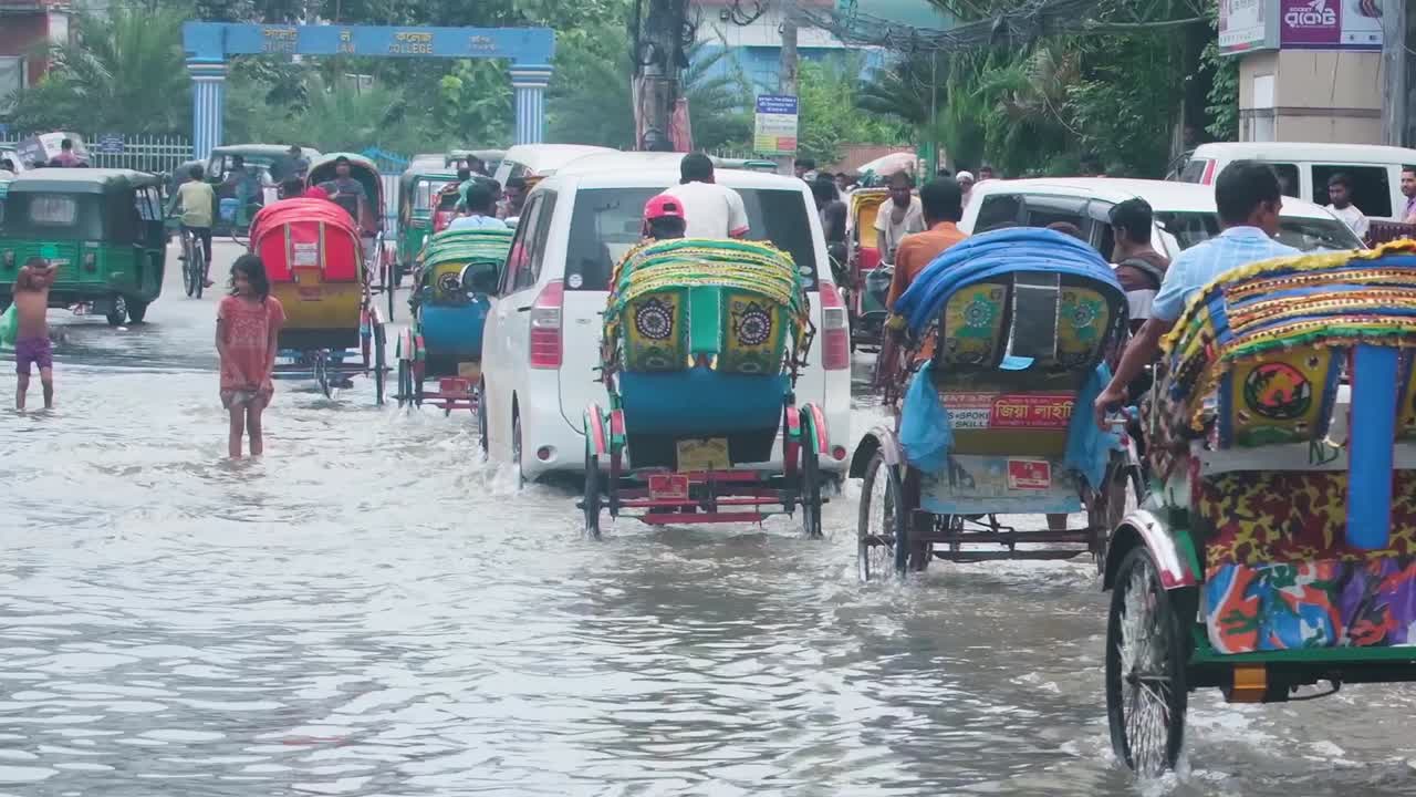 Rickshaws and street children flooded city Bangladesh, South Asia monsoon season