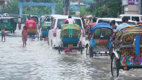 rickshaws and street children flooded city bangladesh, south asia monsoon season