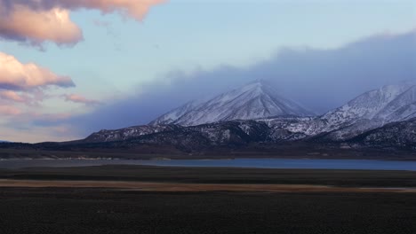 mammoth lakestoms place convict canyon minarets sierra nevada mountains hilltop wild willy's hot springs california aerial drone benton crossing long valley caldera winter sunset clouds pan left