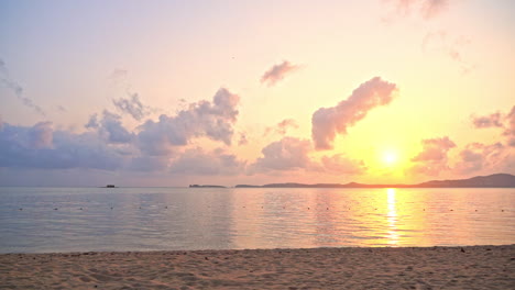 panoramic view of a tropical sunset above empty island beach, peninsula and calm sea with stunning cloudy horizon