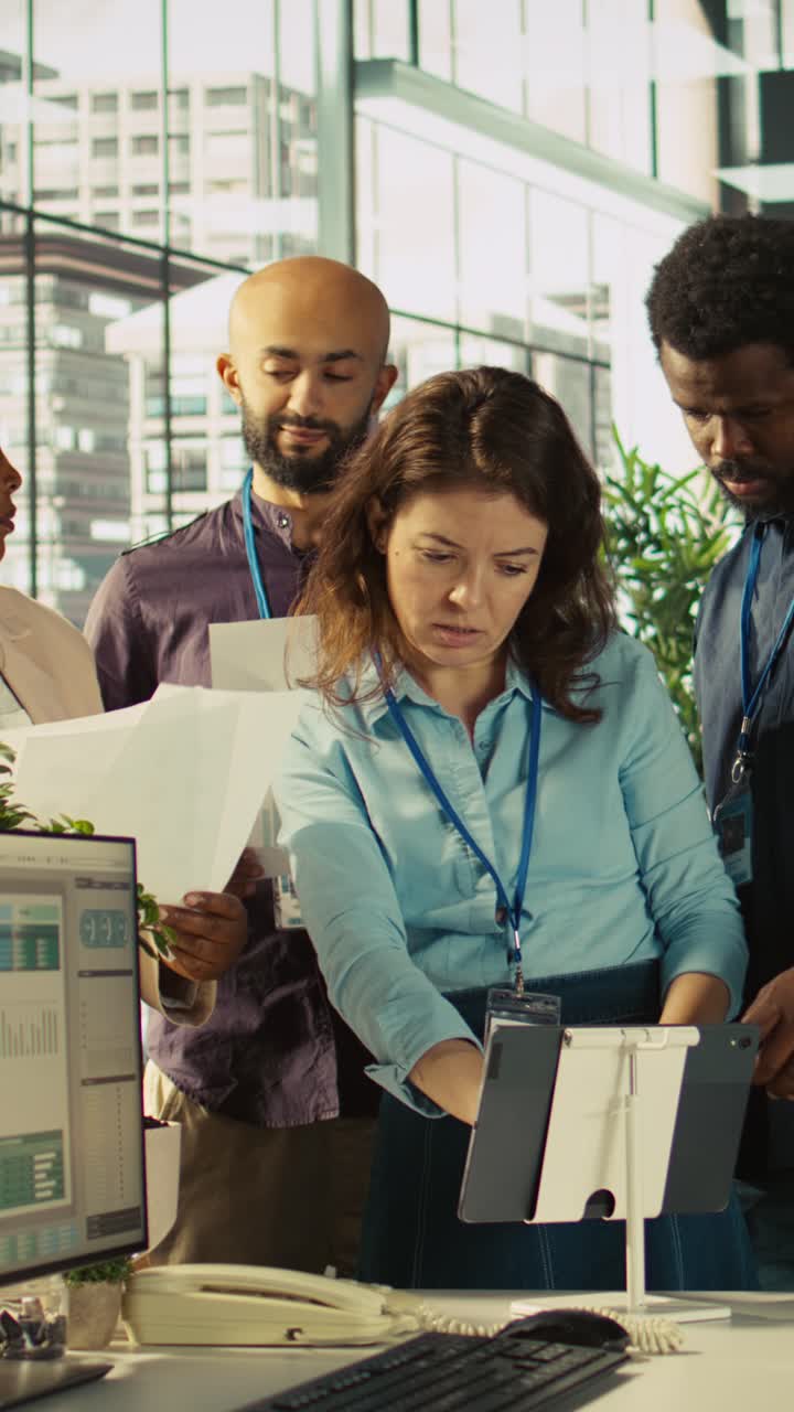 Vertical video Portrait of smiling workers in office working together on finishing project
