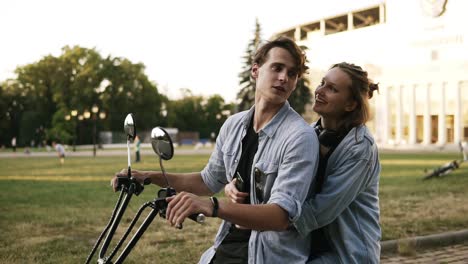 Loving-Couple-Spending-A-Relaxing-Moment-Together-Sitting-On-A-Bike-In-A-Close-Embrace