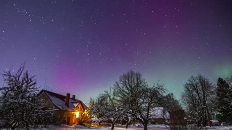 Time-lapse-shot-of-green-and-purple-colored-Northern-Lights-at-night-sky-with-stars-during-snowy-winter-day