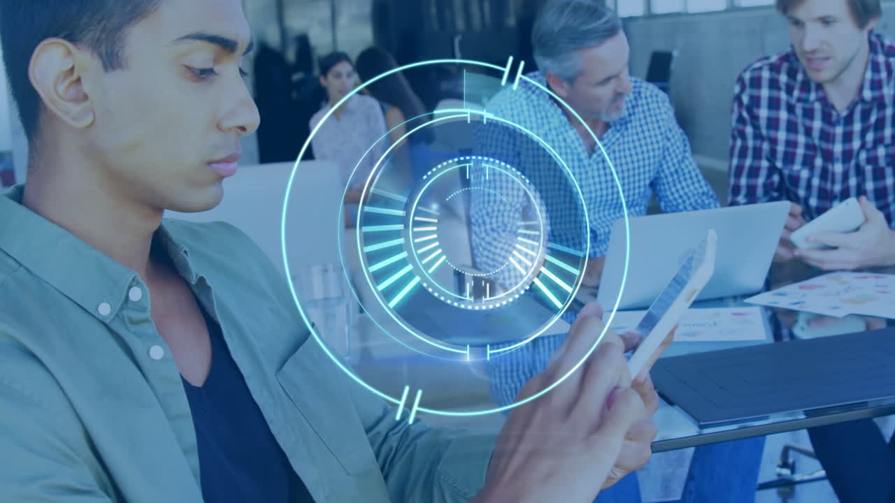 Young man using tablet with digital interface animation over office meeting