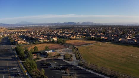 panning aerial shot above recreation center and athletic fields in a desert master-planned community