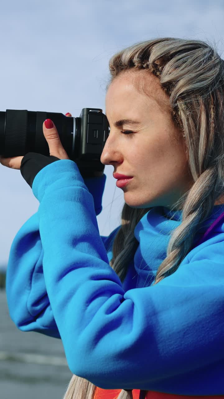 Woman Photographer Taking Pictures Outdoors with a Camera