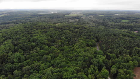 Aerial Shot Of Small River Surrounded By Forest Trees In Beavercreek, Ohio