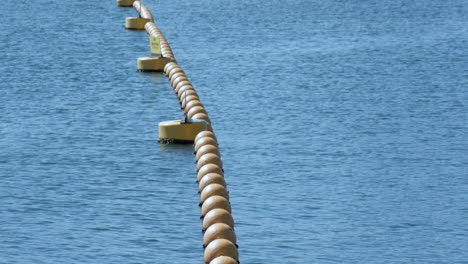 endless sea view with a chain of yellow coloured buoys