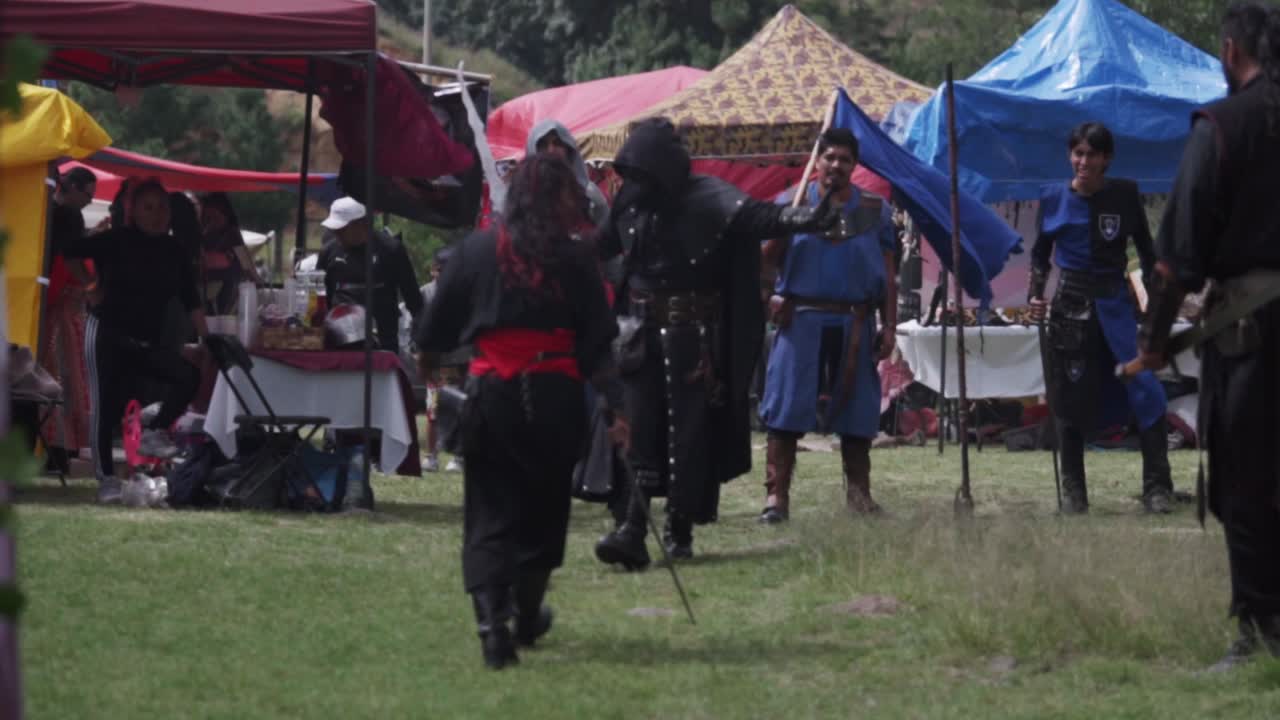 Two warriors of the Middle Ages dueling in a camp. Slow motion