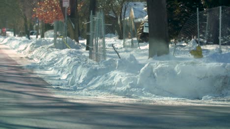 a manhole on the intersection in a rural city in america is covered in snow