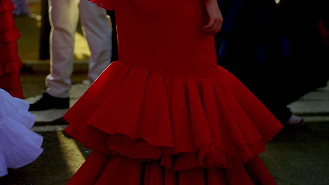 Hand on waist with red nails and blue polka dress during Feria de Abril in Seville