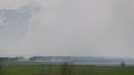 Multiple-helicopters-with-monsoon-buckets-flying-over-Pukaki-Downs-wildfire-2023