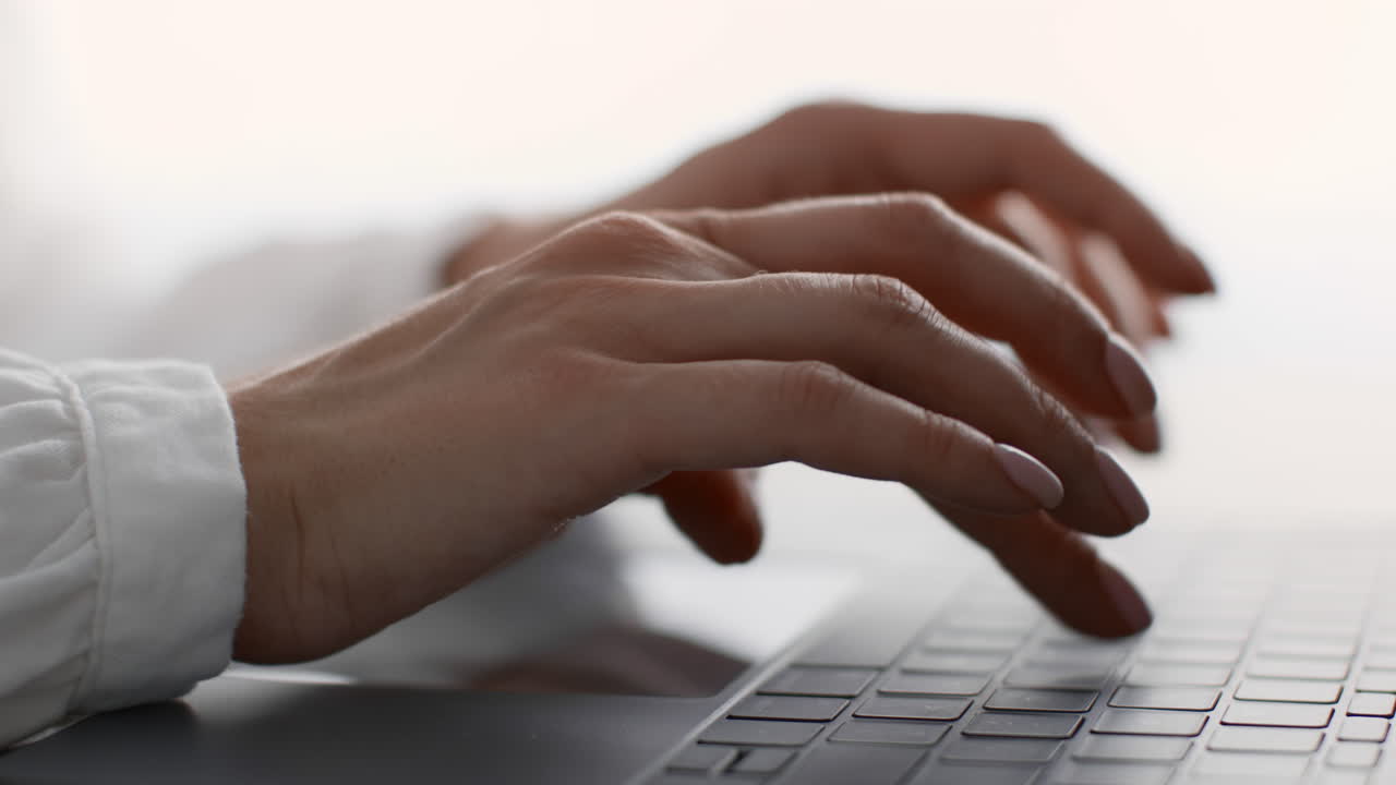 Woman Typing on a Laptop