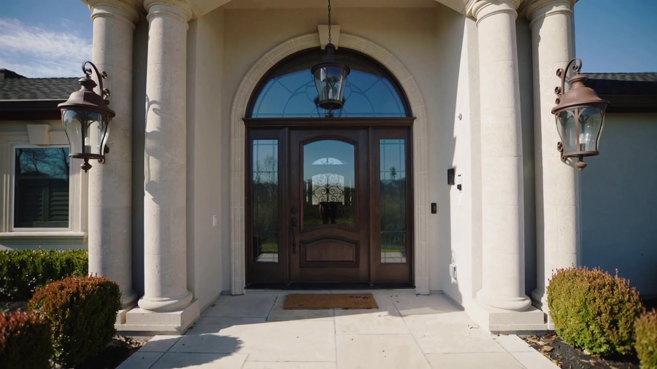 Moving camera pushing forward tightening on arched doorway at home, revealing transom and lanterns