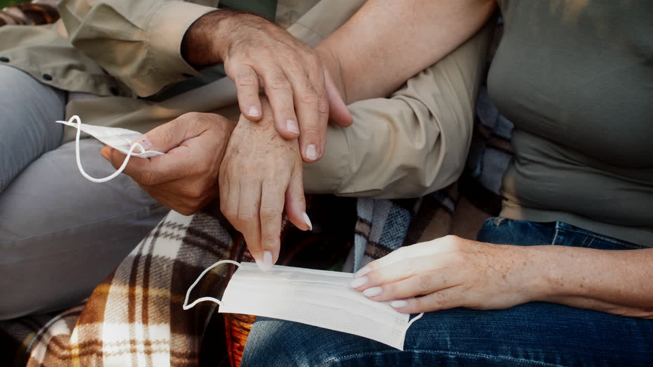 Older Couple Outdoors Wearing Masks