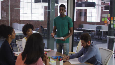 Mixed-race-business-colleagues-sitting-having-a-discussion-in-meeting-room