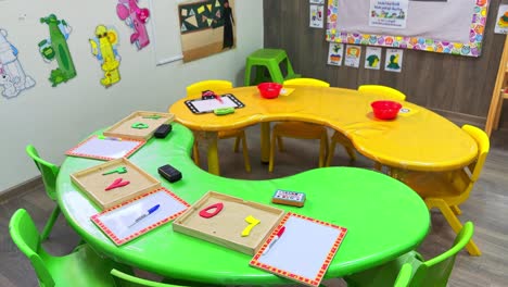 4k footage of vibrant preschool tables with sand trays, whiteboards, and educational toys. ideal for school promos, learning content, or classroom visuals. category: education – preschool setup.