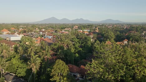 Dense-palm-trees-and-cultural-town-of-Ubud-during-sunrise-in-Bali,-Indonesia