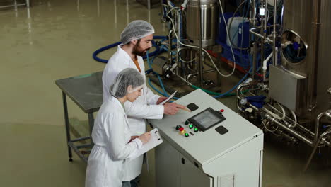 man and woman doing control at brewery