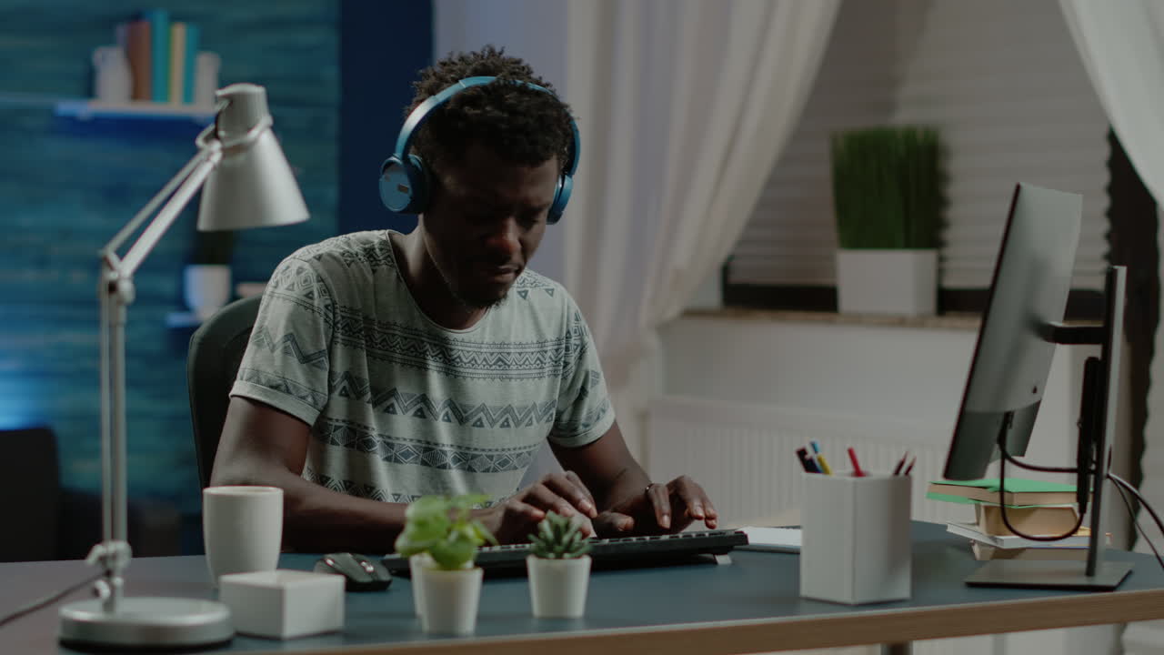 Enrepreneur typing on keyboard and listening to music