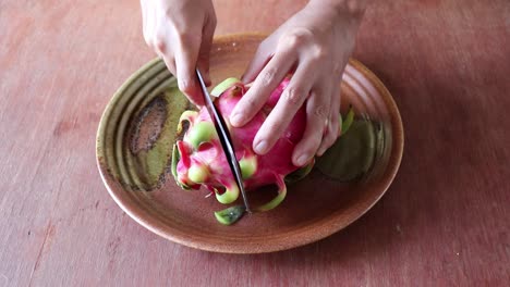 peeling and slicing a red dragon fruit or pitaya