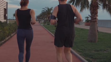 couple running on coastal track