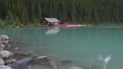 boathouse in lake louise with a leafy forest behind