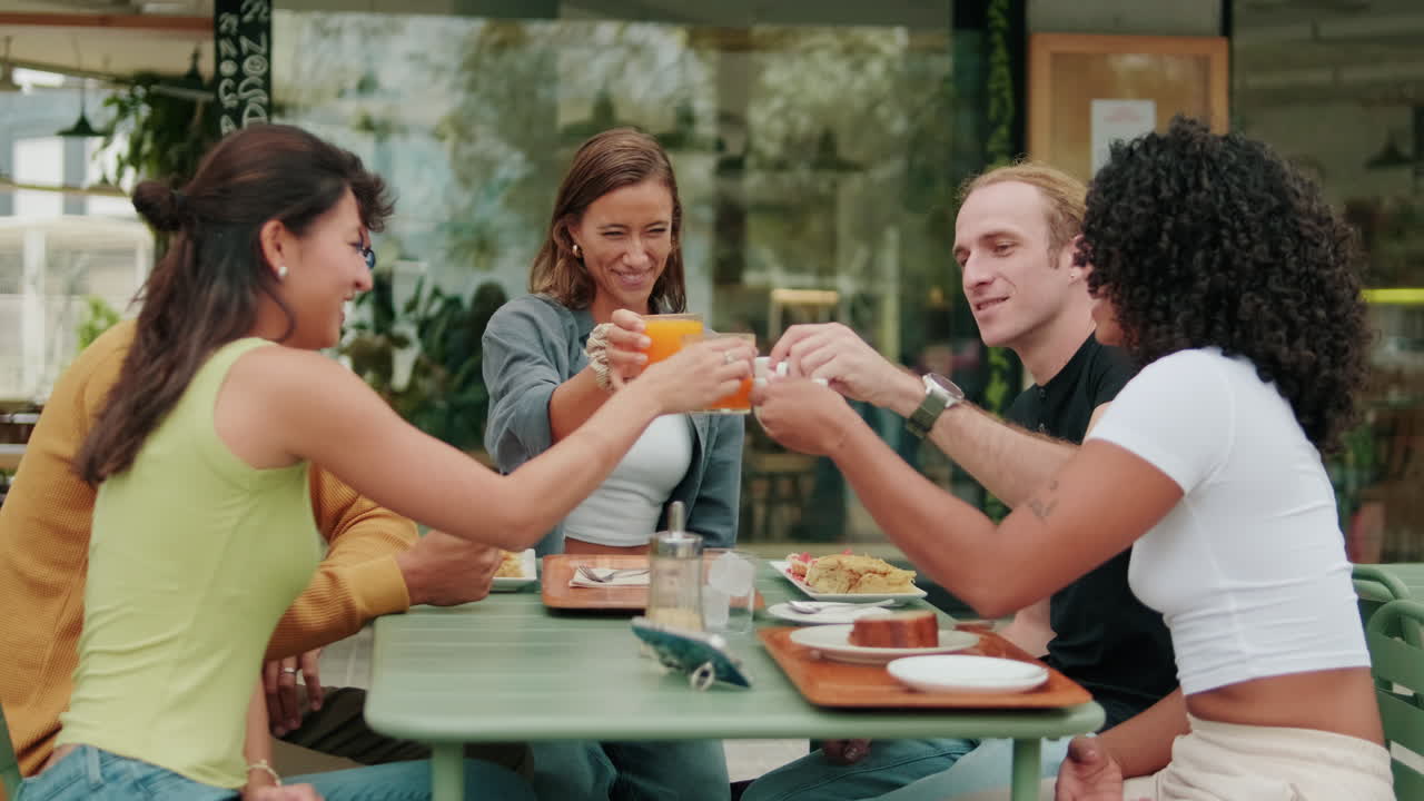 International joyful students drink soft drinks at lunch. Сheers!