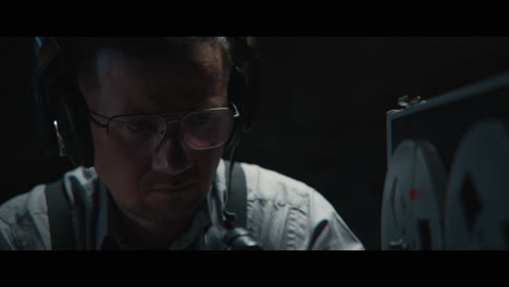 an intelligence officer listens to the wiretap recordings