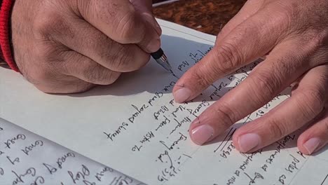 hand writes on notepad