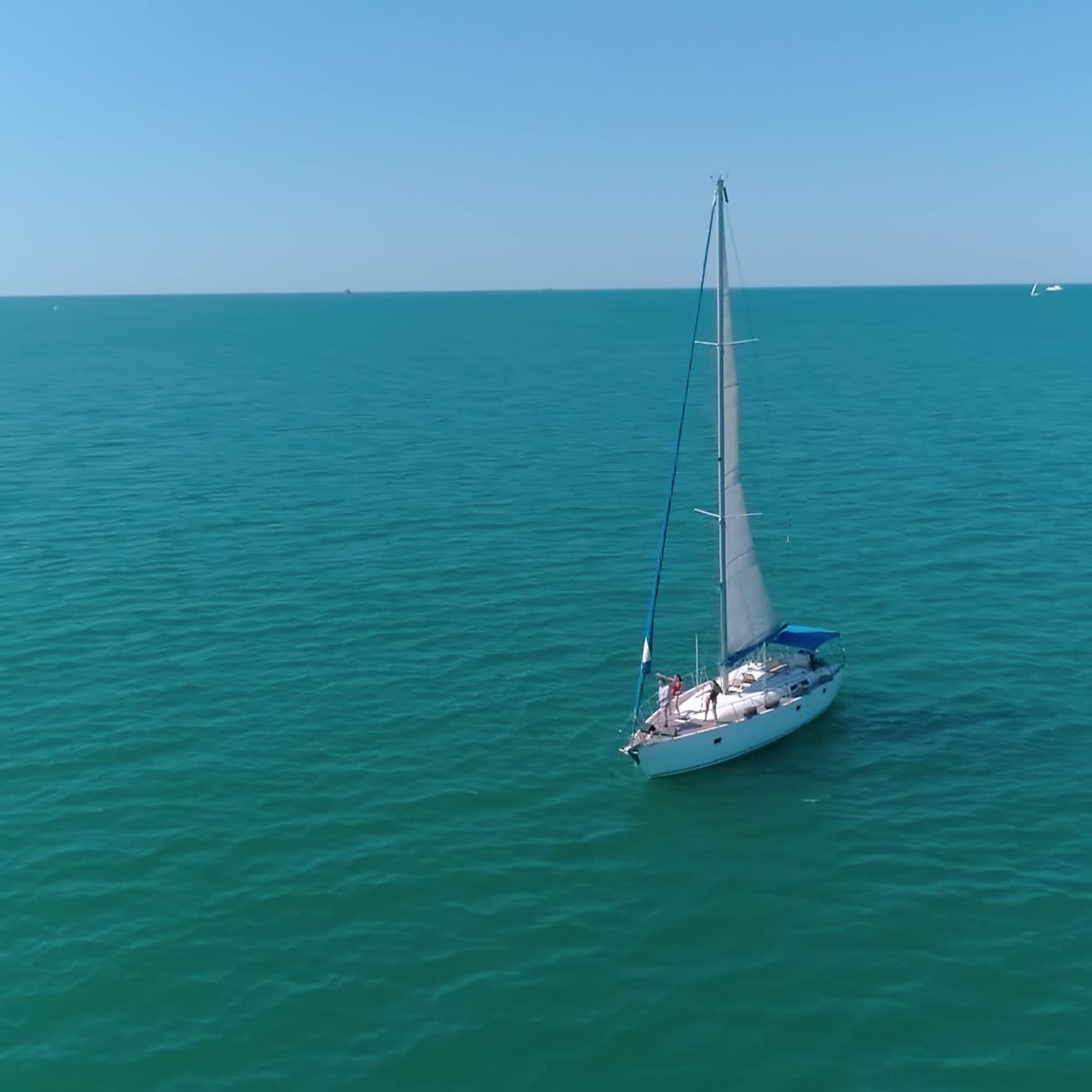 Aerial view of sailing yacht. Drone shot of sail boat traveling in calm waters
